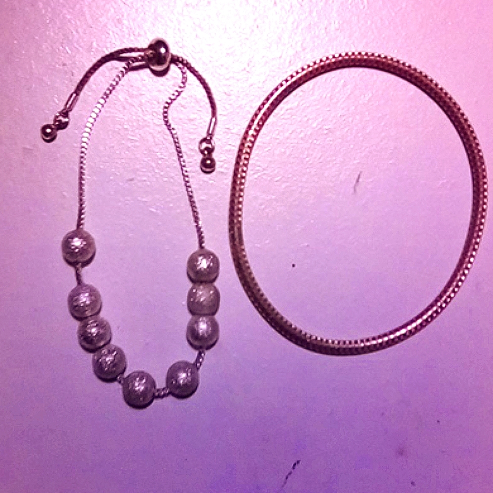 2 bracelets 1 silver tone, one gold tone
